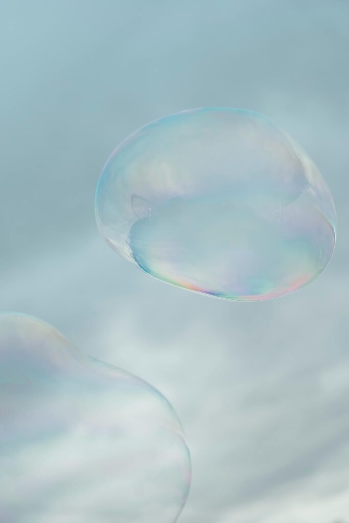 Soft focus image of translucent soap bubbles floating in the sky with a dreamy, artistic tone.